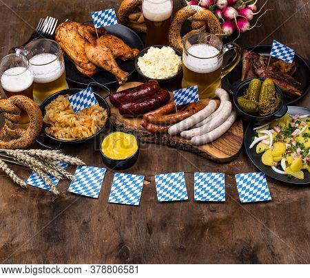 Oktoberfest Dishes: Beer, Pretzel, Sausage, Stewed Cabbage, Potato Salad Half Of Chicken And Ribs