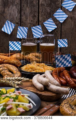 Oktoberfest Dishes: Beer, Pretzel, Sausage, Stewed Cabbage, Potato Salad Half Of Chicken And Ribs