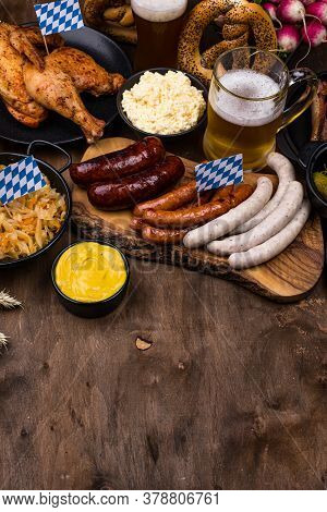 Oktoberfest Dishes: Beer, Pretzel, Sausage, Stewed Cabbage, Potato Salad Half Of Chicken And Ribs
