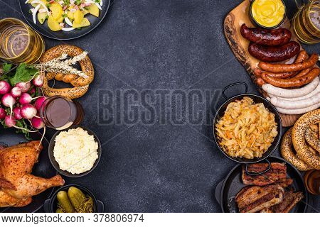 Oktoberfest Dishes: Beer, Pretzel, Sausage, Stewed Cabbage, Potato Salad Half Of Chicken And Ribs