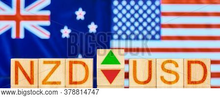 Nzd Usd. Wooden Blocks With The Inscription Nzd Usd With Arrows Symbolizing The Rise And Fall Of The