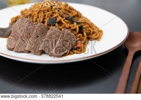 Korean Black Bean Sauce Noodles With Sliced Meat On A Plate.