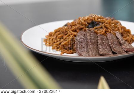 Korean Traditional Jajjangmyeon Black Bean Instant Noodles With Sliced Beef On A Plate.