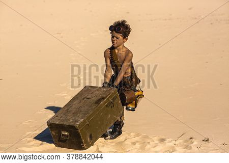 Post-apocalyptic Boy Outdoors In The Desert. Nuclear Post-apocalypse. Life After Doomsday Concept. D