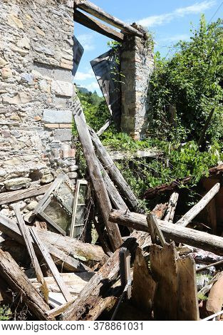 Ruin Of The Old House Destroyed By The Earthquake Made Of Stones And Wooden Planks