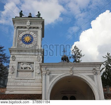 Ancient Clock Tower In Udine City In The Main Square Called Piazza Liberta In Northern Italy