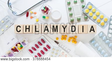 Chlamydia - Word From Wooden Blocks With Letters, Parasitic Bacterium Chlamydia Concept With Pills, 