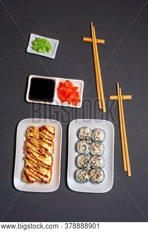 Sushi Rolly, Maki, Nigiri Set Server For Two On Black Stone On Dark Background. Top View Flat Lay