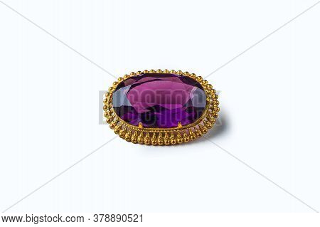 Vintage Antique Brooch With A Large Semi-precious Purple Stone On White Background. Oldfashioned Dec