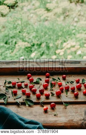 Ripe Cherries On A Wooden Windowsill. Cottagecore Aesthetics. Rustic, Vintage Style Harvest Season C