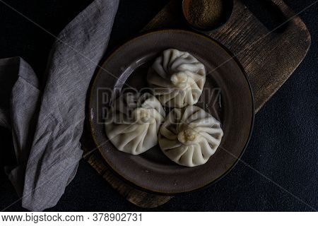 Traditional Georgian Khinkali Dish On Stone Background