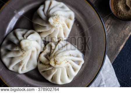 Traditional Georgian Khinkali Dish On Stone Background