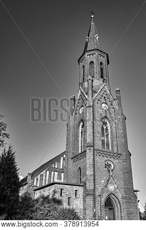 The Tower Of The Historic, Neo-gothic Red Brick Church In The Village Of Sokola Dabrowa In Poland, B