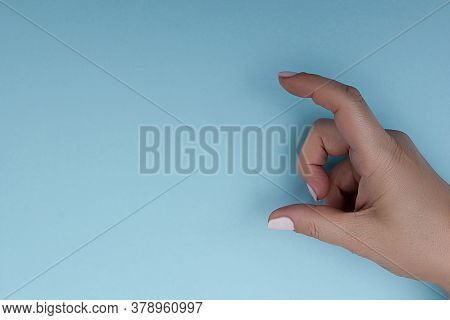 Female Hand Measuring Or Holding Invisible Item While Showing Small Amount Of Something