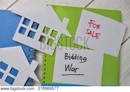 Bidding War And House For Sale Write On Sticky Notes Isolated On Office Desk