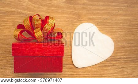 Red Gift Box With Golden Ribbon And White Heart Paper Cut For Surprise Valentines Day Present On Bro