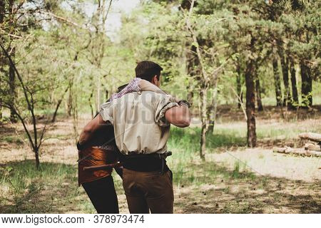 Two Men From The Back In Nature. A Friend Helps A Friend Go.