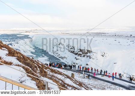 Gullfoss, Iceland - March 4, 2020: Tourists At Observation Deck Look At Gullfoss Waterfall. People A