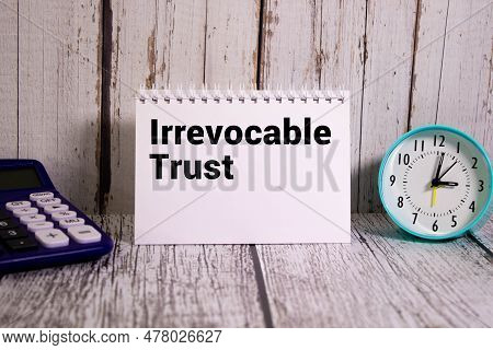 Irrevocable Trust Document With Text On Wooden Background.