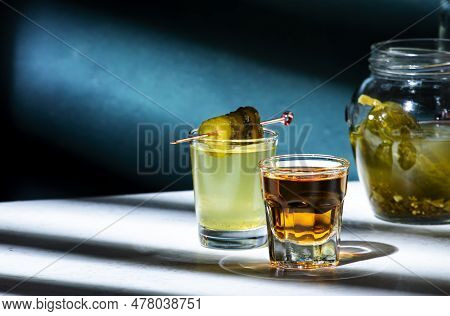Pickleback, Alcoholic Cocktail Drink From Cucumber Pickle And Whiskey In Small Shot Glasses. Hard Li