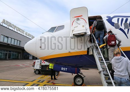 Alghero, Italy - May 30, 2023: Passengers Board Boeing 737-800 Airplane Of Low Cost Airline Ryanair 