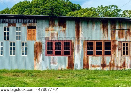 Facade House With Old Zinc Wall. Beautiful Vintage Galvanized Sheet Make Nice Exterior Of Home. Rust
