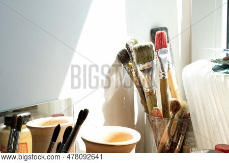Used Art Brushes On The Windowsill. Creative Mess. Selective Focus. Art Space, Workshop.
