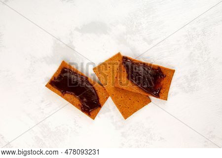Bread Crispy Chips With Vegemite Spread. Tomato Rye Crisps And Yeast Extract Based Sauce. Typical Au