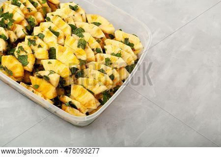 Pineapple Slices With Mint Leaf In Cane Sugar Syrup, Close-up. Sweet Fruit Dessert In Plastic Tray O