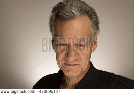Portrait Of A Mature Man With Graying Hair Wearing A Black Shirt 60plus Looking Down