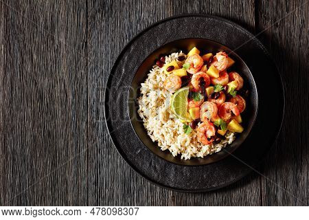Caribbean Grilled Shrimps With Black Beans, Mango Pineapple Salsa Served With Brown Rice In Black Bo