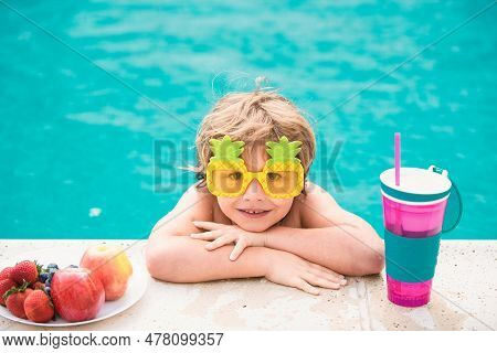 Cute Boy Relaxing In Swim Pool. Summer Vacation Concept. Little Boy With Fresh Cocktail On Watter Po