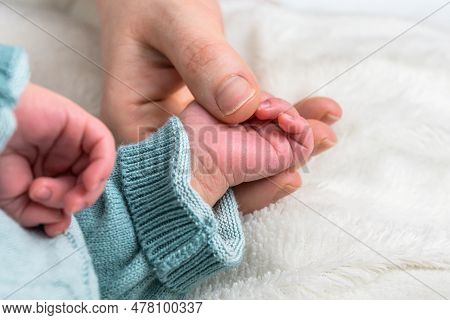 Sweet Tiny New Born Baby Hand Hold Mum Index Finger. Concept Relationship Between Mother Or Parants 