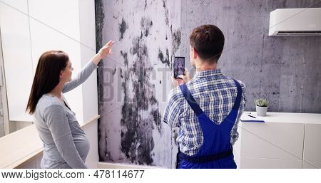 Mold Damage On House Wall. Woman Looking At Wet Moisture