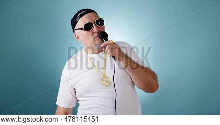 Music Party Star In Sunglasses With Microphone. Man On Stage