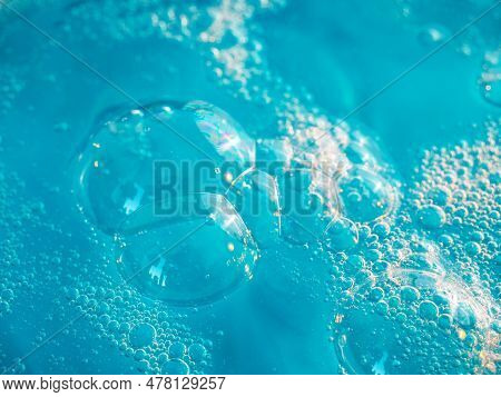 Texture Of Soap Bubbles In Close Up. Bubble Bath. Gel For Washing Or Washing Hands.blue Background W
