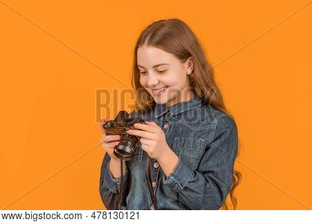 Happy Teen Girl Photographer Looking At Camera Screen Yellow Background, Photographing