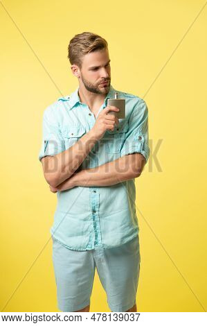 Man Holding Perfumery. Man With Perfumery Isolated On Yellow. Man With Perfumery In Studio