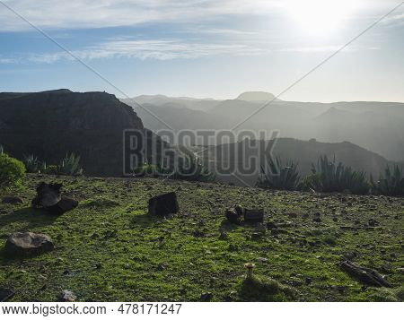 View From Green Plateau On Top Of La Merica Mountain With Agave Cacti, Valley And Hills In Fog Haze.