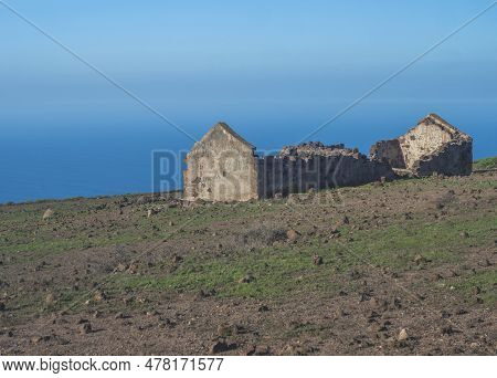 Abandoned Ruins Of Farm House At Flat Plateau On Top Of La Merica Mountain With Cacti, Stones And Se