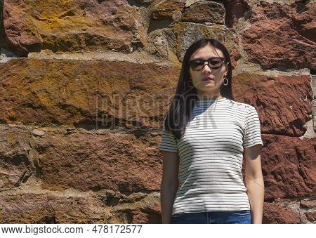 A Unhappy Chinese Woman Standing Near An Old Stone Wall At The Newgate Prison In East Granby Connect