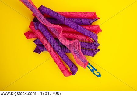 Soft Curler Spirals Or Curlformers With Hook On Yellow Background, Top View. Fashion Accessory For F