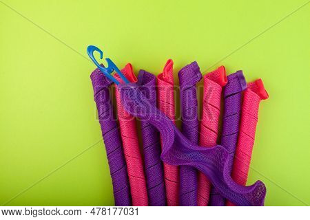 Hair Curling Spirals Or Soft Curlformers And Special Hook On Green Background. Fashion Accessory For
