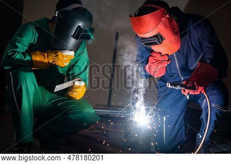 Metal Welding Steel Works Using Electric Arc Welding Machine To Weld Steel At Factory. Metalwork Man