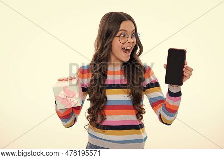 Birthday Present, Bonus For Mobile User. Portrait Of Teenager Child Girl Holding Gift Box And Cell P