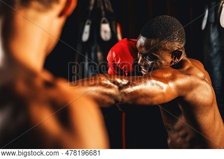 African American Black Boxer Punching At Trainer Or Coach Wearing Punching Mitts As Boxing Bag Train