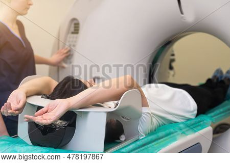 Doctor Doing Computed Tomography For Female Patient Stock Photo. Medicine Diagnostic Concept