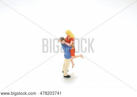 A Mini Of The Couple Standing On Board