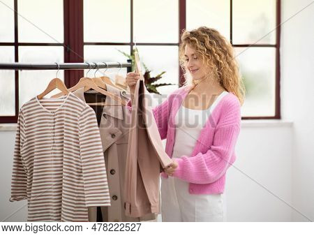 Consumerism Concept. Portrait Of Beautiful Young Female Shopping In Fashion Store