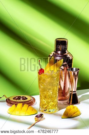 Mango Rum Collins Alcoholic Cocktail With Rum, Syrup, Ginger Beer, Lemon Juice, Ice And Fresh Mango.